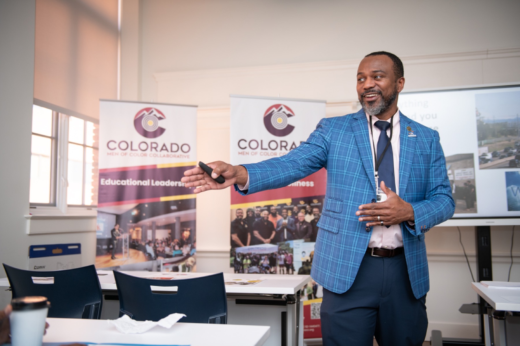 A school leader presenting to educators at a recruiting table