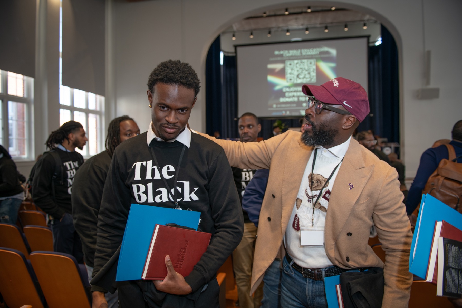 An educator welcomes a young man at the 2026 Summit at Howard University